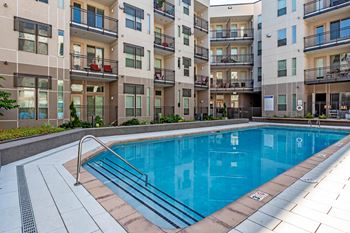 A swimming pool in front of apartment buildings at Regatta Sloans Lake Apartments, Denver